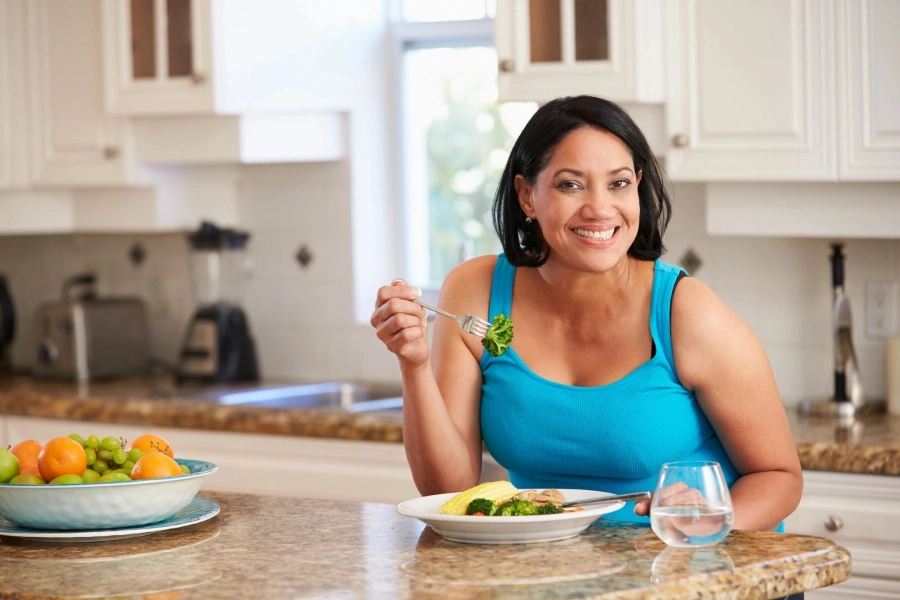 A woman sitting at the table eating food.