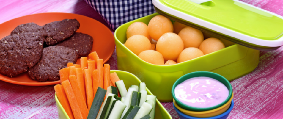 A table with bowls of food and containers