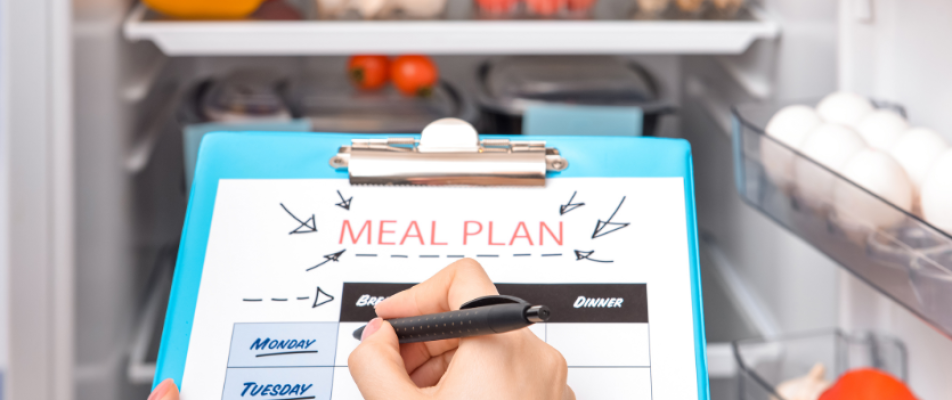 A person writing on a meal plan