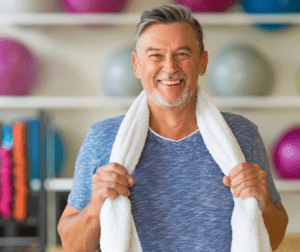 A man holding onto some towels in his hands