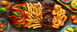 A wooden tray with various food items on it.