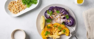 A plate of food with broccoli and lemon.