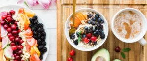 A bowl of cereal with fruit and nuts on top.