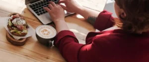 A person sitting at a table with a laptop