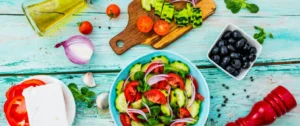 A bowl of salad on top of a table.