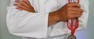 A person in white shirt holding hands with another person.